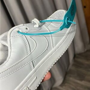 White Sneakers with Teal Tag